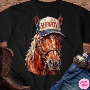 May include: Black t-shirt featuring a detailed illustration of a horse wearing a baseball cap with the word "HOWDY" on it. The horse has a brown and white coat and is wearing a bridle. The image also shows a pair of cowboy boots and jeans.
