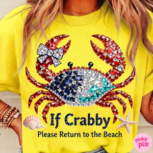 May include: Yellow t-shirt featuring a crab design made of red, white, blue, and clear rhinestones. The crab has a bow and the text "If Crabby Please Return to the Beach". A seashell and starfish are also visible.