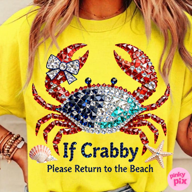 May include: Yellow t-shirt featuring a crab design made of red, white, blue, and clear rhinestones. The crab has a bow and the text "If Crabby Please Return to the Beach". A seashell and starfish are also visible.