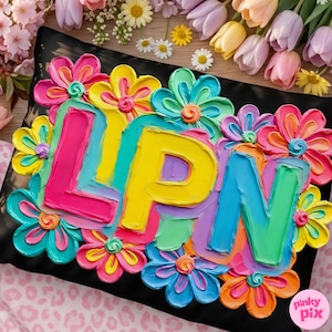 May include: A black cushion adorned with brightly coloured, textured flowers and the letters "LPN". The letters are painted in vivid shades, surrounded by flowers in pink, yellow, blue, and orange, creating a cheerful, artistic design.