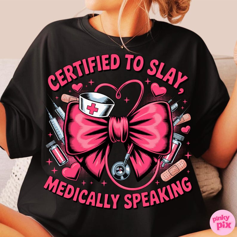 May include: Black t-shirt with a pink graphic that reads "CERTIFIED TO SLAY, MEDICALLY SPEAKING." The design includes a pink bow, nurse's hat, stethoscope, syringes, bandages, and hearts.