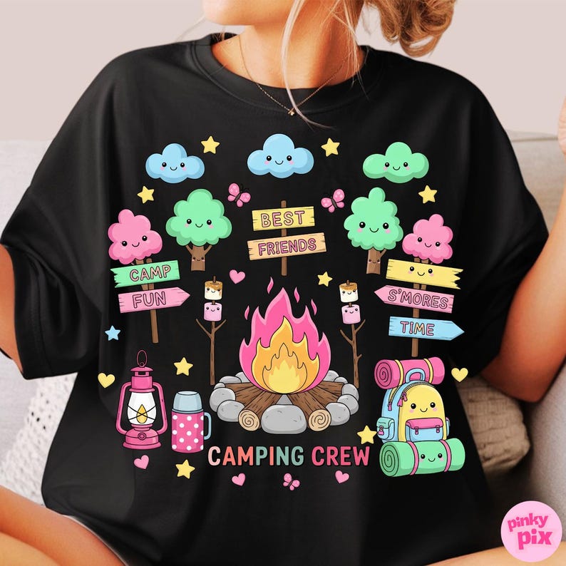May include: Black t-shirt with a colorful camping-themed graphic. The design includes a campfire, trees, clouds, stars, and the words "CAMPING CREW", "BEST FRIENDS", and "S'MORES TIME". A lantern and backpack are also featured.