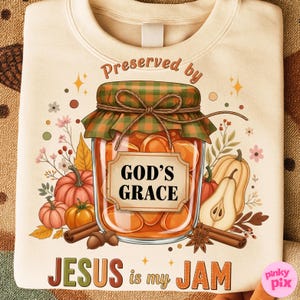 May include: Cream-colored sweatshirt with a graphic featuring a jar of preserves labeled "GOD'S GRACE" and the text "JESUS is my JAM." The design includes pumpkins, pears, cinnamon sticks, and floral accents.