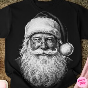 May include: Black t-shirt featuring a detailed black and white illustration of Santa Claus. The image shows Santa with a long white beard, glasses, and a traditional hat with a fluffy white trim. The design is a classic representation of the holiday figure.