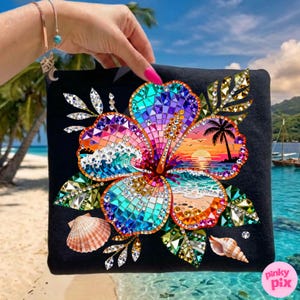 May include: Black square decorative pillow featuring a vibrant, mosaic-style hibiscus flower design. The flower incorporates beach and sunset imagery, with seashells and crystal accents. The pillow has a Pinky Pix logo.