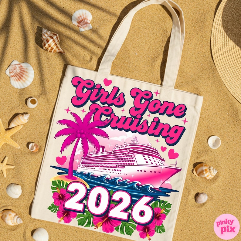 May include: A cream-colored tote bag with the text "Girls Gone Cruising 2026" in pink and blue. The design includes a pink cruise ship, palm tree, and hibiscus flowers. The bag is on a sandy surface with seashells.