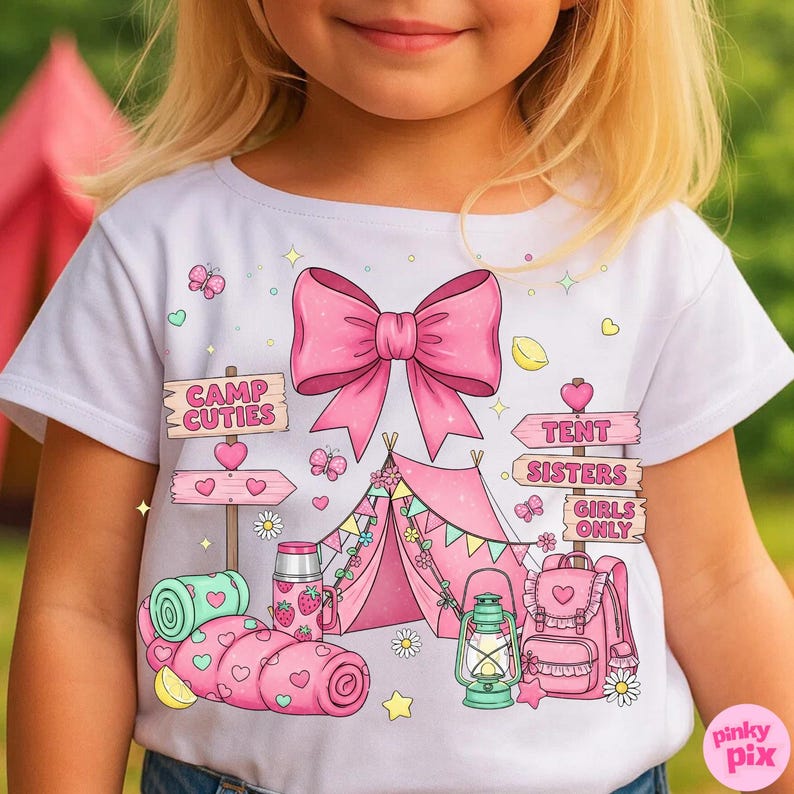 May include: White t-shirt with a pink bow and camping graphics. The design includes a pink tent, sleeping bag, backpack, and signs that read "Camp Cuties," "Tent Sisters," and "Girls Only."