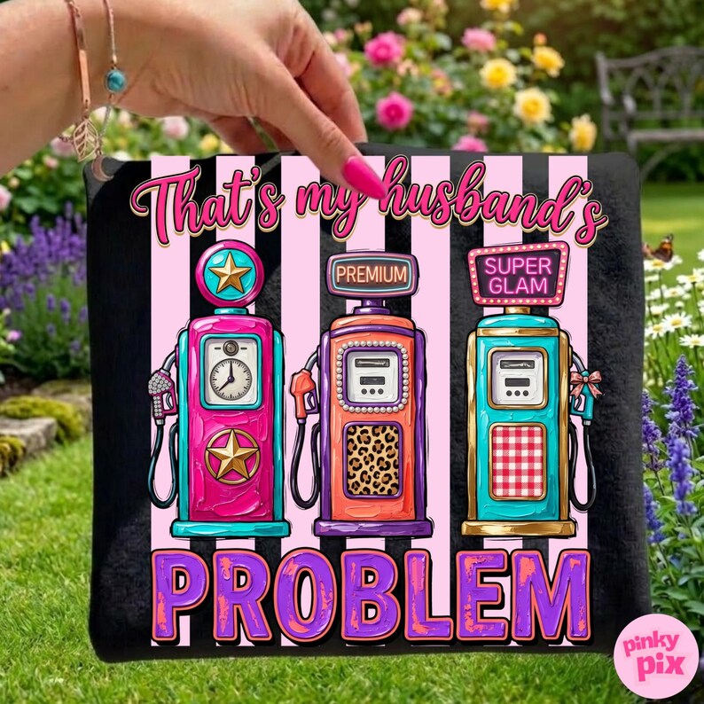May include: Black tote bag with a graphic of three colorful vintage gas pumps. The text "That's my husband's PROBLEM" is above the pumps in pink and purple. The pumps are pink, orange, and teal with star and leopard print details.
