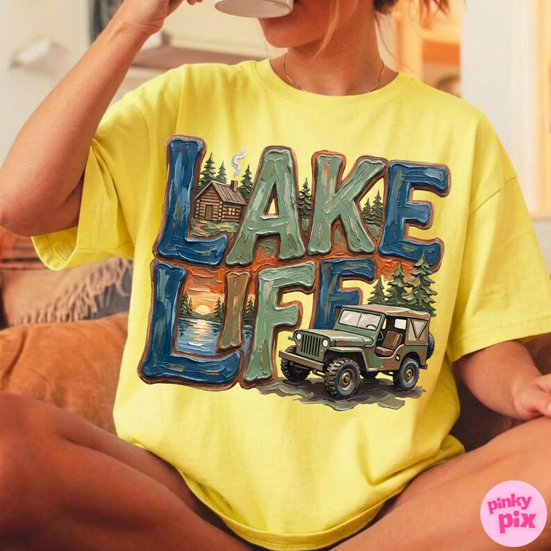 May include: Yellow t-shirt with a graphic that says "LAKE LIFE" in blue and green letters. The graphic includes a cabin, a sunset over a lake, and a green jeep.
