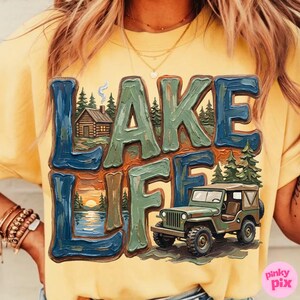 May include: Yellow t-shirt with a graphic that says "LAKE LIFE" in blue and green block letters. The graphic includes a cabin, trees, a lake scene, and a green jeep.