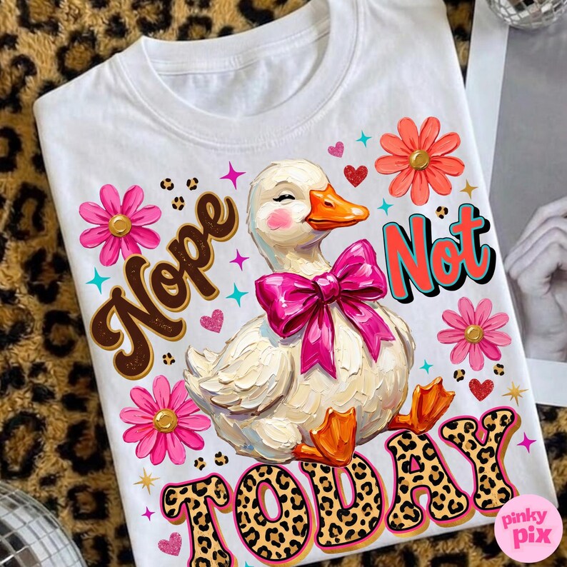 May include: White t-shirt featuring a cartoon duck with a pink bow, surrounded by pink and orange flowers, hearts, and the words "Nope Not Today" in a playful font. The word "Today" has a leopard print design.