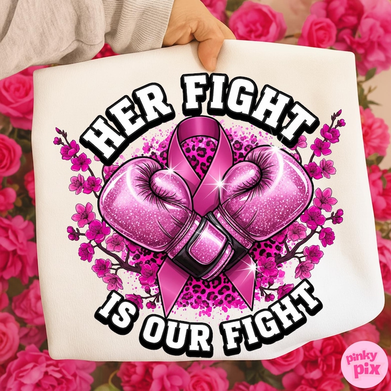 May include: A white tote bag featuring a pink ribbon, boxing gloves, and floral accents. The text reads "HER FIGHT IS OUR FIGHT" in bold, black letters. The design includes a pink leopard print background and pink flowers.