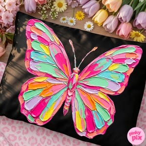 May include: A black pillow featuring a vibrant, textured butterfly design. The butterfly is rendered in a palette of pink, green, yellow, and orange, creating a striking contrast against the dark background. The pillow is a decorative home accent.