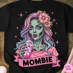 May include: Black t-shirt featuring a zombie woman with pink and blue hair, wearing a pink shirt and flower crown, drinking from a pink iced beverage. The word "MOMBIE" is displayed on a pink glitter banner. Pink stars are in the background.