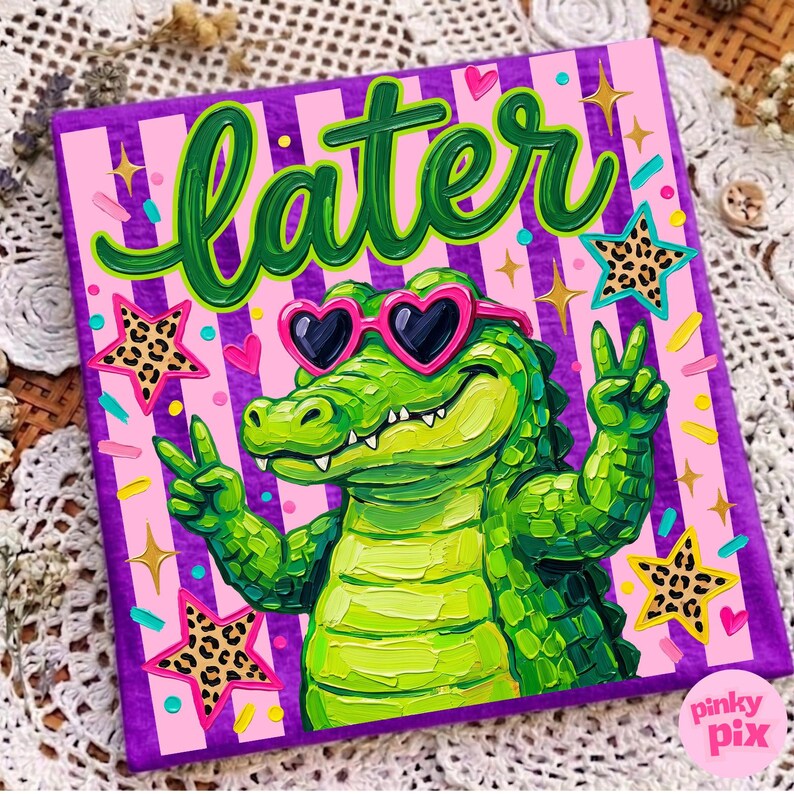 May include: A vibrant square canvas art piece featuring a green alligator wearing heart-shaped sunglasses and giving a peace sign. The word "later" is written in green script above the alligator. The background is pink with purple stripes and star accents.