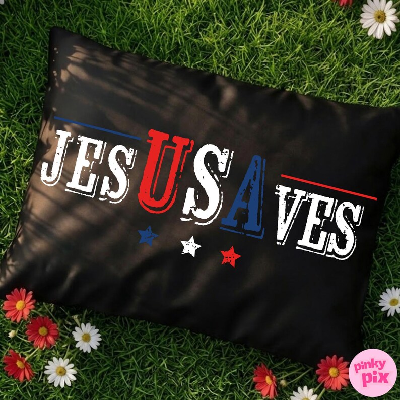 May include: Black rectangular pillow with the text "JESUS SAVES" in white, red, and blue. The pillow has a patriotic theme with stars and stripes. The pillow is on green grass with red and white flowers.