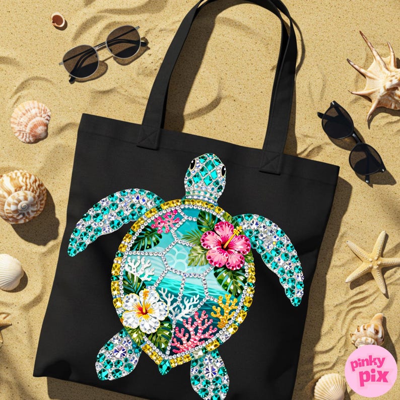 May include: Black tote bag featuring a colorful sea turtle design. The turtle has a turquoise and crystal-like shell with a tropical scene, including pink and white flowers, coral, and ocean waves. Sunglasses, seashells, and a starfish are scattered around the bag on a sandy surface.