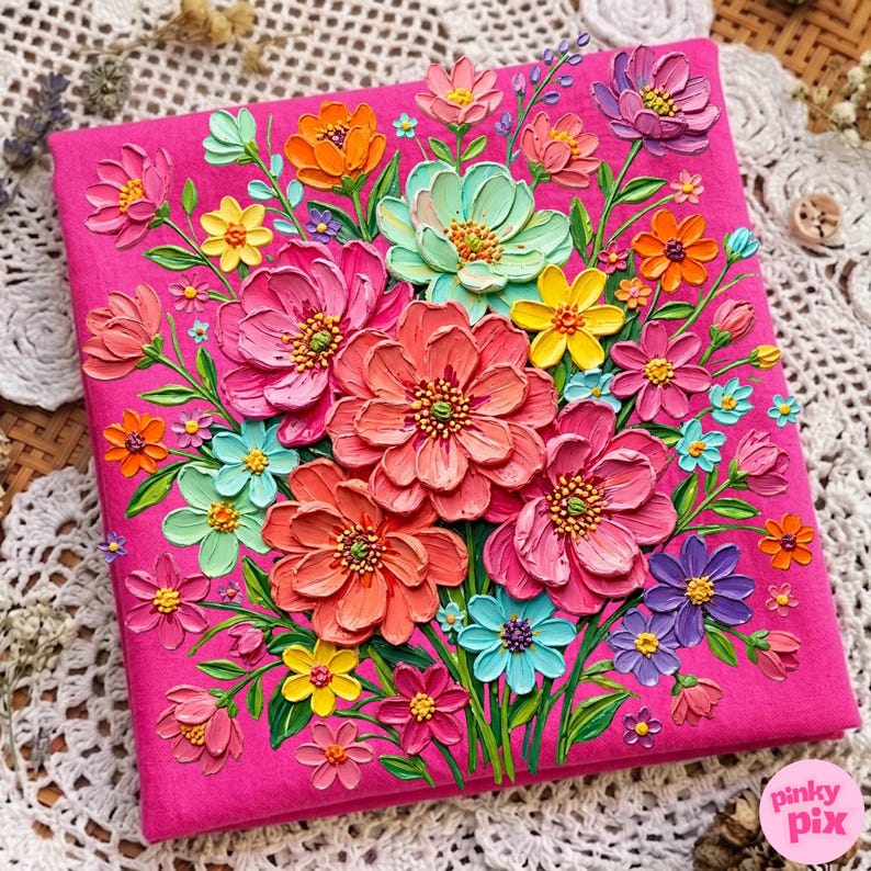 May include: A vibrant, textured artwork featuring a bouquet of colorful flowers in shades of pink, orange, yellow, blue, and purple. The flowers are arranged on a bright pink background, creating a three-dimensional effect. The artwork is a square shape.