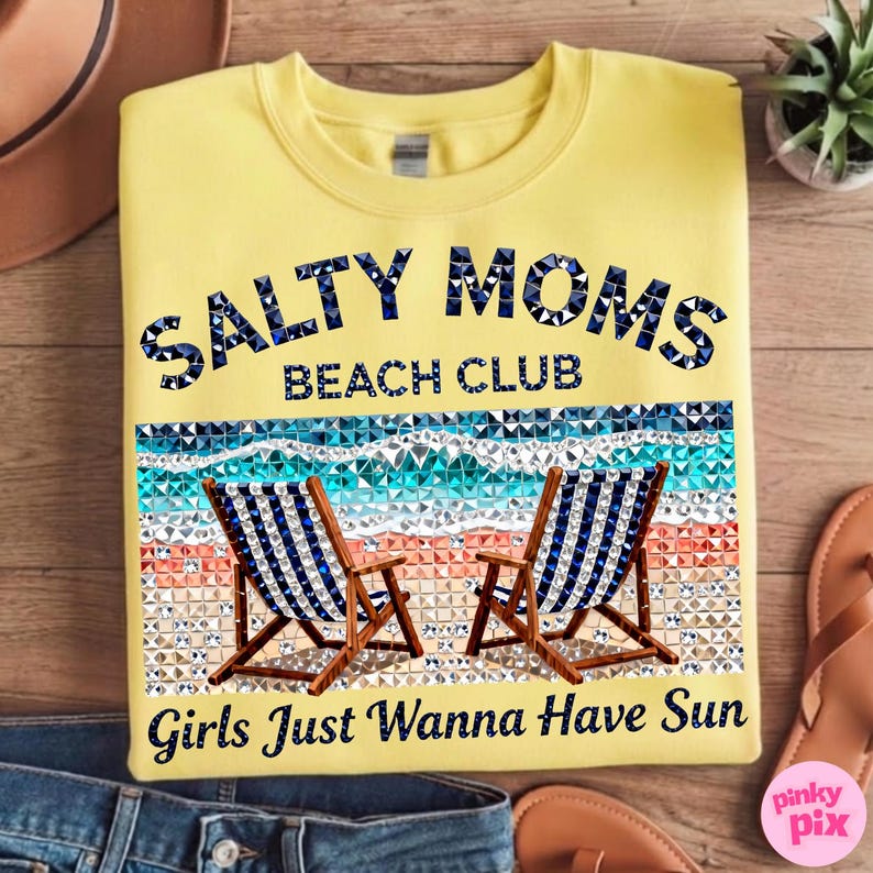 May include: Yellow sweatshirt with the text "Salty Moms Beach Club" in blue and white. The design includes two beach chairs and the phrase "Girls Just Wanna Have Sun".