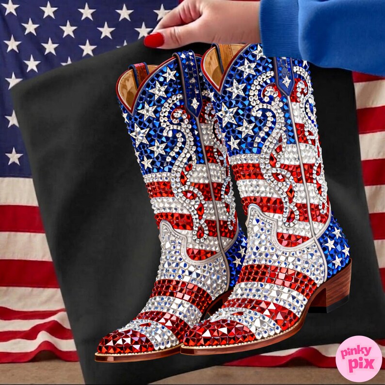 May include: A pair of cowboy boots with a patriotic design. The boots feature the American flag with red, white, and blue colors, and are embellished with sparkling rhinestones. The boots have a brown heel and are set against a black background.
