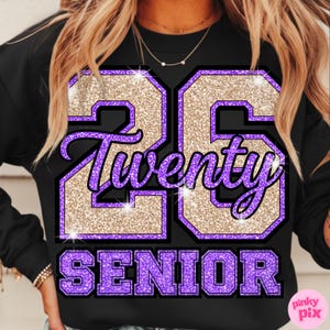 May include: Black sweatshirt with a glittery gold and purple graphic. The graphic features the number "26", the word "Twenty", and the word "SENIOR" in a collegiate style. The design has a sparkly, textured appearance.