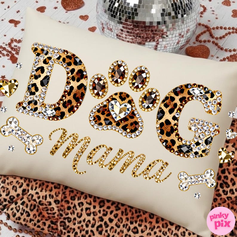 May include: Cream-colored rectangular pillow with the words "Dog Mama" in gold script and leopard print letters. The paw print and letters are embellished with rhinestones. Decorative dog bone accents are also included.