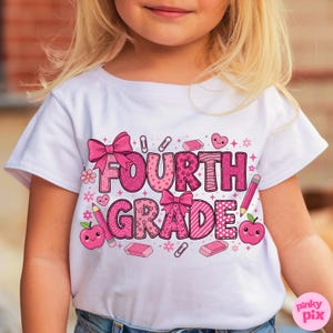 May include: White t-shirt with a pink graphic that says "FOURTH GRADE". The design includes pink bows, pencils, apples, hearts, and other school-themed elements. The shirt is worn by a child.