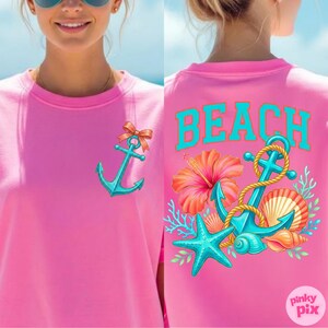 May include: A pink crew neck t-shirt with a teal anchor graphic and a coral bow. The back of the shirt features the word "BEACH" in teal, along with a teal anchor, starfish, seashells, and a hibiscus flower.
