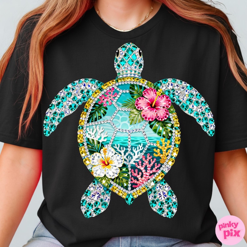 May include: Black t-shirt featuring a detailed sea turtle design. The turtle's shell is adorned with turquoise and clear crystals, surrounding a tropical scene with flowers, coral, and ocean waves. The design includes pink, white, yellow, and green elements.