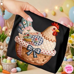 May include: Black tote bag with a quilted chicken design. The chicken is in a basket with a blue bow. The chicken has a red comb and a yellow beak. The design incorporates floral and gingham patterns.