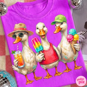 May include: A purple t-shirt featuring a whimsical illustration of three ducks. One duck wears sunglasses and a straw hat, holding a drink. Another holds a popsicle, and the third has an ice cream cone. The ducks are depicted in a cartoon style.