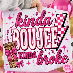 May include: A white fabric square featuring the text "kinda BOUJEE kinda broke" in pink and cream lettering. The design includes a leopard print tumbler with a pink bow, a pink and white checkered lightning bolt, and various pink star accents.