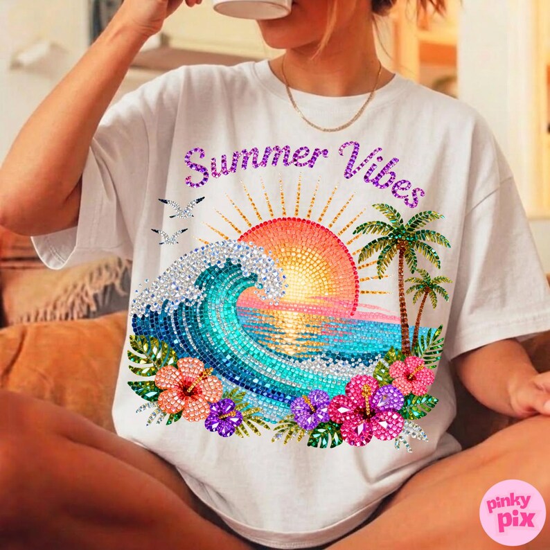 May include: White t-shirt with a colorful graphic design featuring a sunset, ocean wave, palm trees, and flowers. The text "Summer Vibes" is displayed above the graphic. The shirt is a casual, relaxed fit.