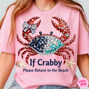 May include: Pink t-shirt featuring a bejeweled crab design with red, blue, and white accents. The crab has a bow and the text "If Crabby Please Return to the Beach". A seashell and starfish are also featured.