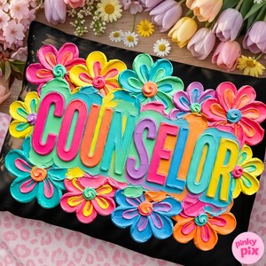 May include: A black pillow with the word "COUNSELOR" in colorful, raised lettering, surrounded by vibrant, textured flowers in shades of pink, yellow, blue, and orange. The pillow is decorated with a floral design.