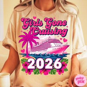 May include: Beige t-shirt with a pink graphic that says "Girls Gone Cruising 2026". The design includes a pink cruise ship, palm tree, hearts, and tropical flowers. The shirt is short-sleeved.