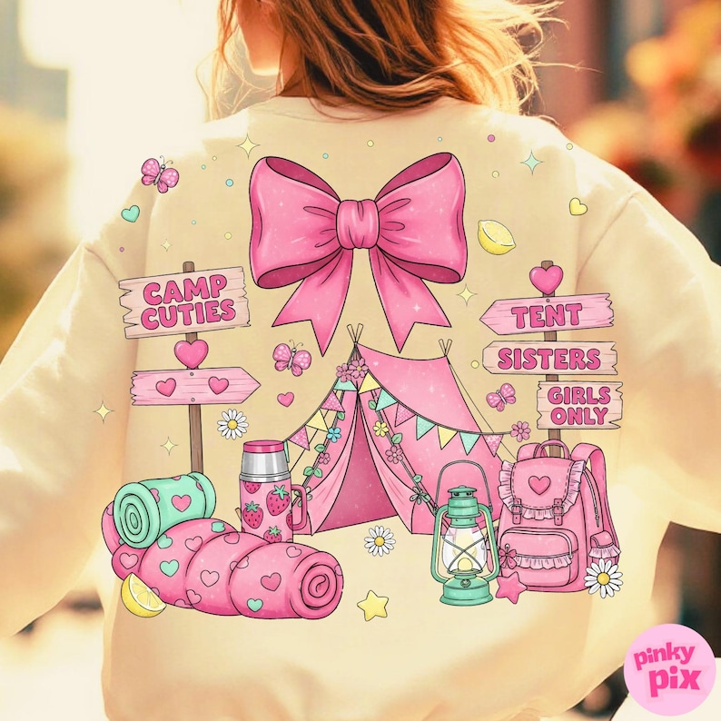 May include: Cream sweatshirt featuring a pink bow and a camping scene. The design includes a pink tent, camping equipment, and the text "Camp Cuties" and "Tent Sisters Girls Only". Butterflies and hearts are scattered around the illustration.