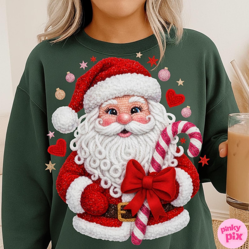 May include: Dark green sweatshirt featuring a detailed Santa Claus design. Santa is wearing a red suit and hat with white trim, holding a candy cane and a red bow. The design includes pink and gold stars, hearts, and ornaments. The text "pinky pix" is in the bottom right corner.