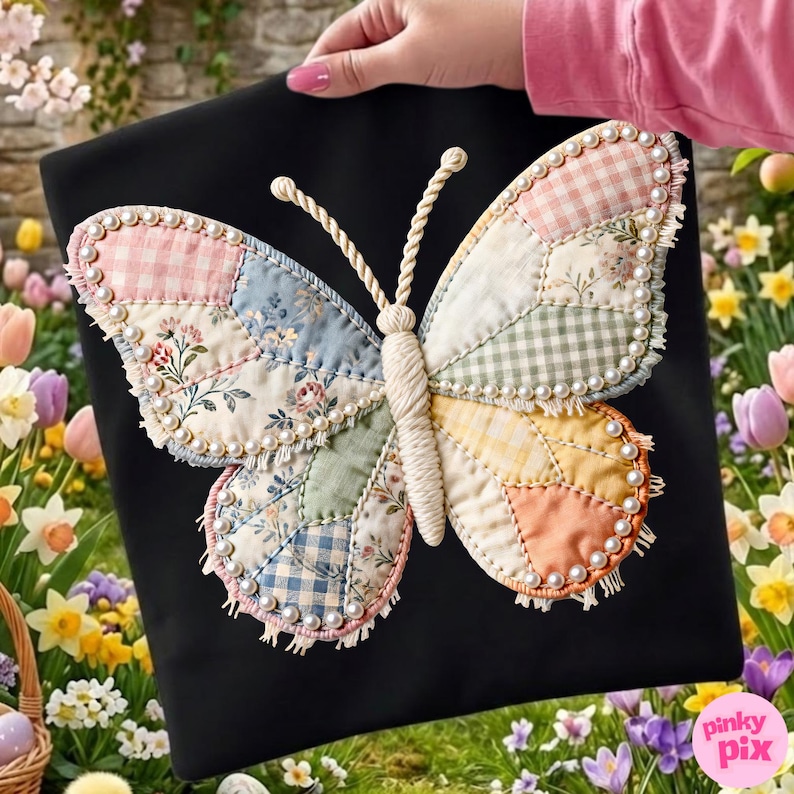 May include: A black fabric square featuring a large, central butterfly appliqu&eacute;. The butterfly is constructed from various pastel-coloured fabric patches, including gingham and floral patterns, outlined with white faux pearls and frayed edges.