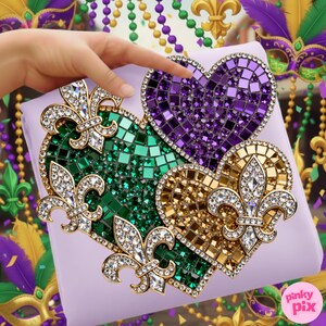 May include: Three heart-shaped decorative items with mosaic tile designs in green, purple, and gold. Each heart features a fleur-de-lis design with clear crystal accents. The items are on a lavender surface.