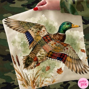May include: A mallard duck in flight with wings composed of a patchwork of various plaid, floral, and solid fabric patterns in shades of green, brown, red, and yellow, set against a watercolor background with cattails and falling autumn leaves.