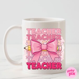 May include: White ceramic mug featuring a pink bow and pencil design. The text "TEACHER" is repeated in pink lettering on the mug.
