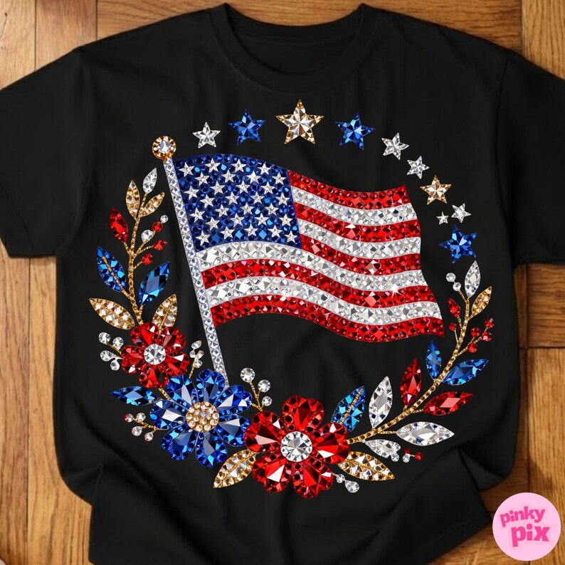 May include: Black t-shirt featuring a sparkling American flag design. The flag is surrounded by a wreath of red, white, and blue floral and star embellishments. The design is centered on the front of the shirt.