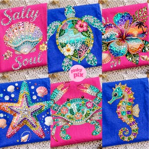 May include: A collection of six colorful beach-themed designs. The designs include a seashell with the text "Salty Soul", a sea turtle, a hibiscus flower, a starfish, a crab, and a seahorse. Each design is embellished with sparkling gems.