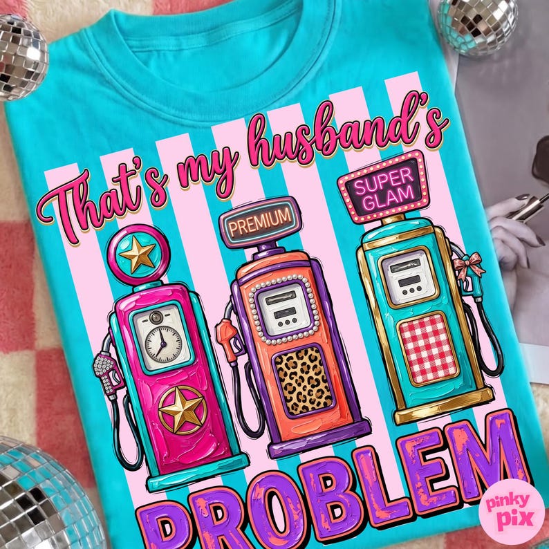 May include: A turquoise t-shirt with a graphic of three vintage gas pumps in pink, orange, and teal. The text reads "That's my husband's PROBLEM" in pink and purple. The pumps have star and leopard print details.