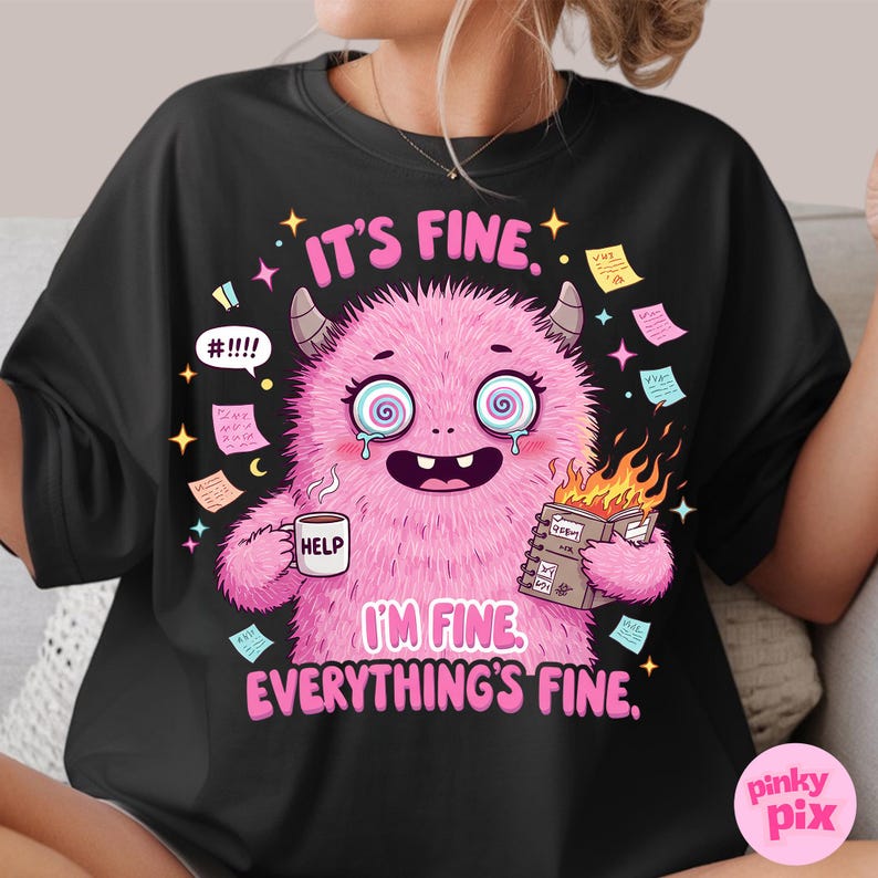 May include: Black t-shirt with a pink monster holding a mug that says "Help" and a notebook that says "RECON". The monster has a distressed look on its face and is surrounded by notes. The text on the shirt reads "It's fine. I'm fine. Everything's fine."