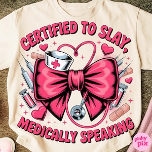 May include: Cream-colored t-shirt with a pink graphic. The graphic features a large pink bow, a nurse's hat, a stethoscope, syringes, bandages, and the text "CERTIFIED TO SLAY, MEDICALLY SPEAKING" in pink.