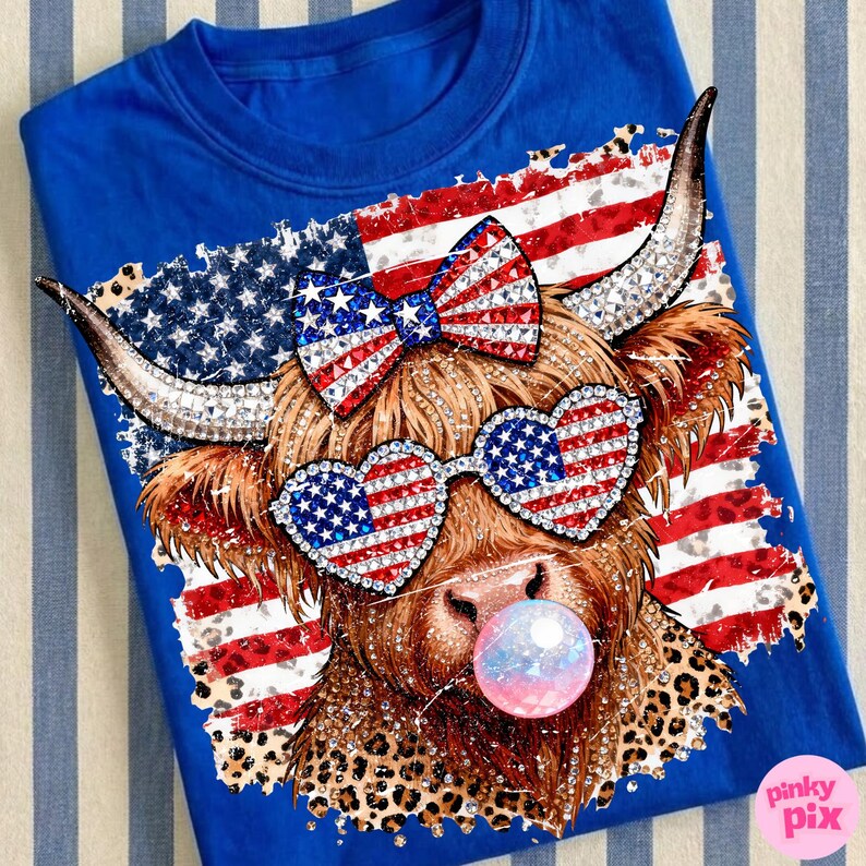 May include: Royal blue t-shirt featuring a whimsical cow design. The cow wears heart-shaped sunglasses and a bow, both adorned with an American flag pattern. The design includes a bubble and a leopard print.