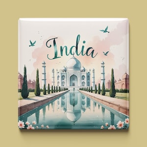 May include: A watercolour illustration of the Taj Mahal in India. The image features a white building with a reflecting pool in front of it. The text "India" is written in cursive above the building.