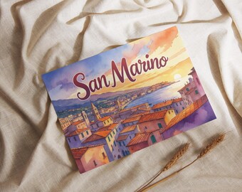 May include: Watercolor print of San Marino, featuring a cityscape with orange rooftops, a blue sea, and a sunset sky. The text "San Marino" is written in a decorative font. Two wheat stalks are in the foreground.